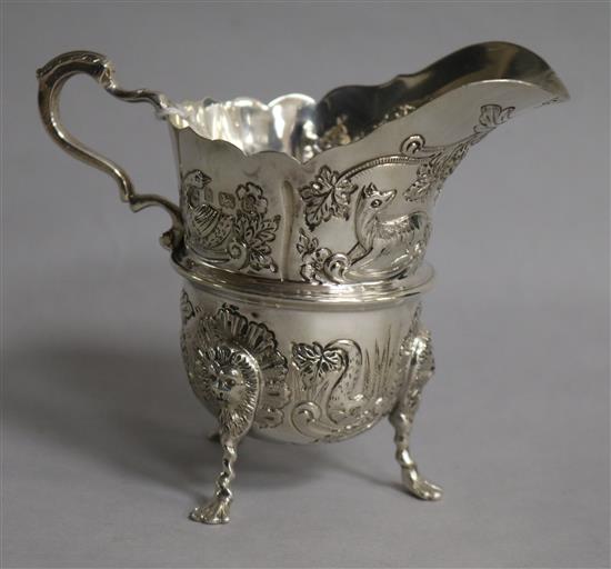 An Edwardian embossed silver cream jug, Williams Ltd, Birmingham, 1904, height 95mm.